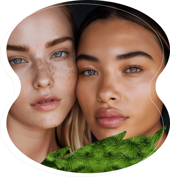Two women with clear skin and minimal makeup, showcasing the natural results of microblading and nanobrows, pose closely together against a dark background with a green palm leaf in the foreground.